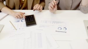 Accountant showing a monthly management report to a cafe owner