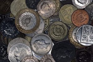 Calculator and UK pound coins beside moving boxes, representing move financial planning