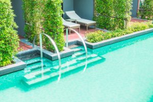Outdoor pool with curved steel handrails and pool automation systems